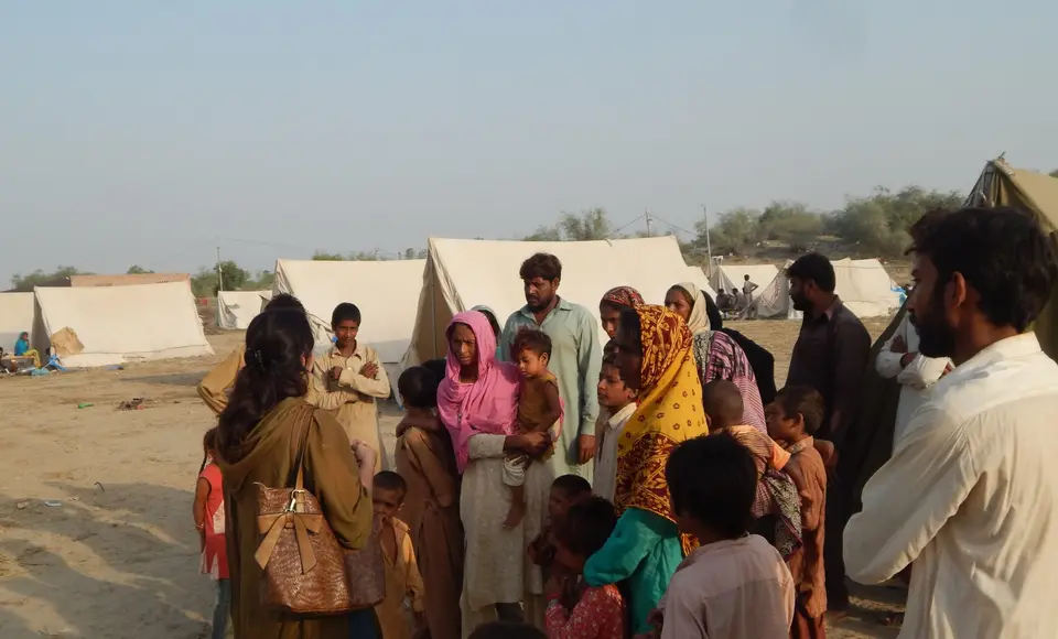 Flood-affected families gathered near relief tents