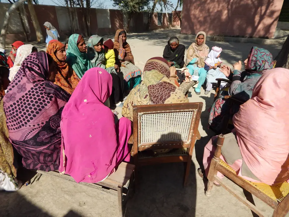 Women of a community organisation gathered in a circle